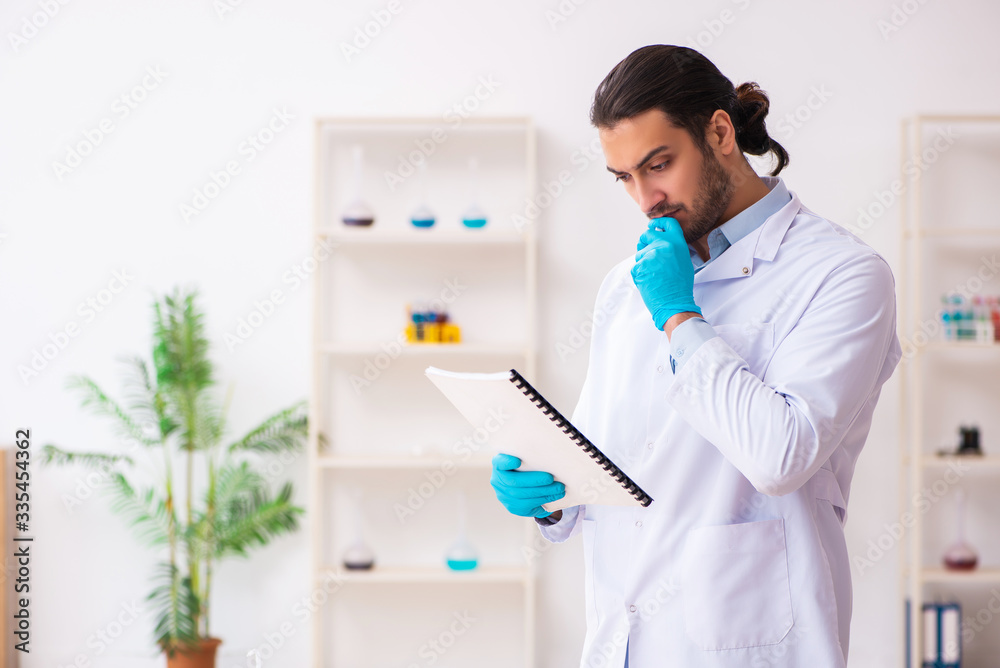 Young male chemist working in the lab