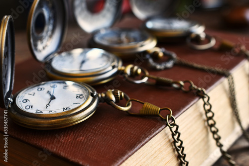 Four Vintage Pocket Watches and Antique Book photo