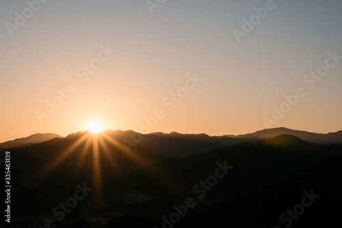 Silhouette of mountain and the sun and sky,landscape background. © Khun Mix