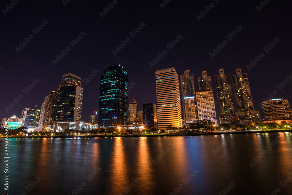 Modern building light with pond public park at night Modern building light with pond public park at night