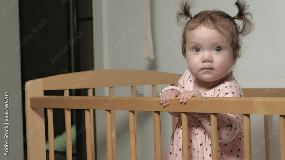 Little child is a cheerful girl in a baby chair. Little child is a cheerful girl in a baby chair.