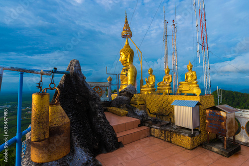 Golden statue on mountain sunruse with fog photo