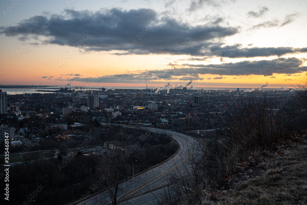 Industrial Cityscape during Sunrise with Vibrant Sky and Factories