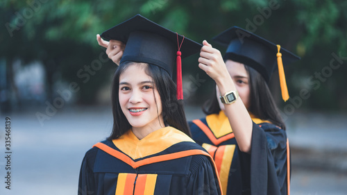 Young charming Asian feemale gradutes cerebrate her degree graduation after accomplish diploma certificate in commencement day. Congratulations on Education achievement photo