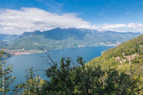 Big european lake in the mountains seen from above. Lake Maggiore, Italy, with the city of Cannobio on the left. Amazing summer landscape