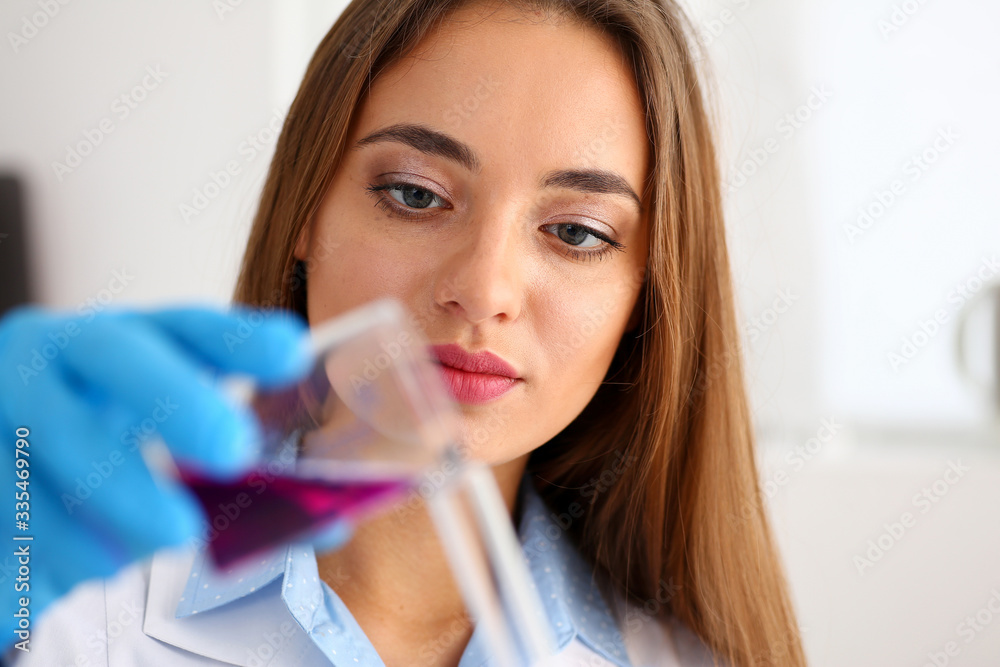 Technician hold in arms in protective gloves sample bottle with poison fluid portrait. Medical worker in uniform use reagent tube for virus infection exam or biological toxic reaction, drug creation Technician hold in arms in protective gloves sample bottle with poison fluid portrait. Medical worker in uniform use reagent tube for virus infection exam or biological toxic reaction, drug creation
