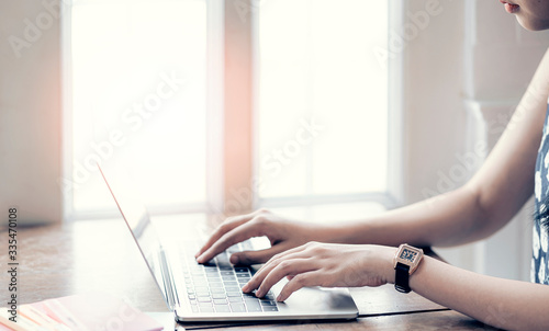 woman working from home, using laptop while sitting at home.