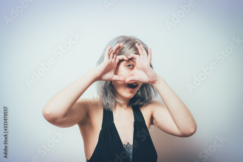 woman making a hand heart frame