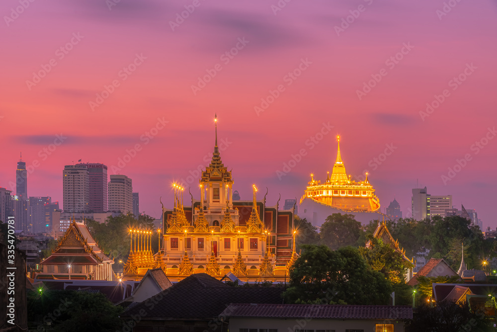 Fototapeta premium Loha Prasat Wat Ratchanatda and Golden Mountain pagoda during sunrise in Bangkok, Thailand.
