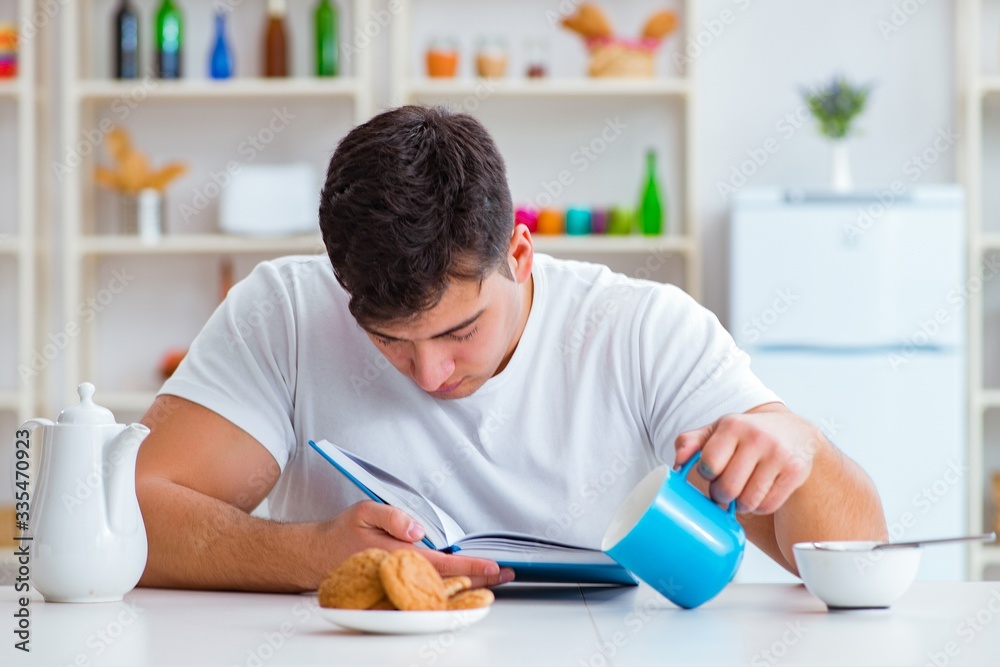 Man falling asleep during his breakfast after overtime work Man falling asleep during his breakfast after overtime work