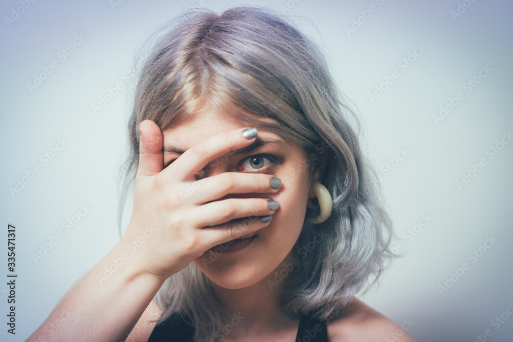 Woman covers his face by hand Woman covers his face by hand