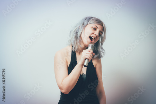 Young girl singing with microphone