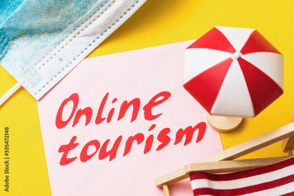 Fototapeta premium Note with text and beach accessories. Concept on the topic of online tourism in a home quarantine environment
