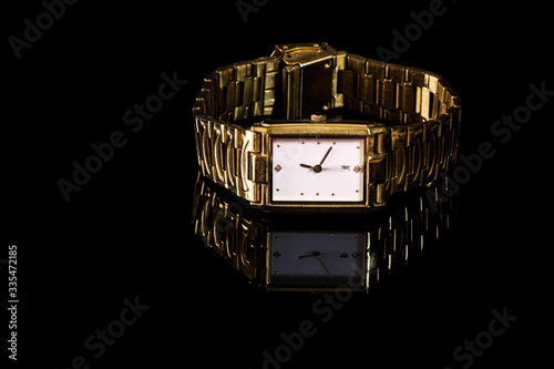 gold plated wrist watch with golden metallic strap