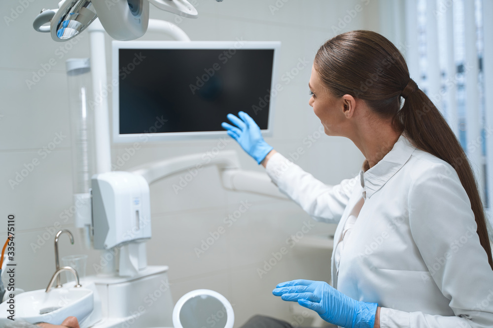 Dentist using digital screen during consultation stock photo Dentist using digital screen during consultation stock photo