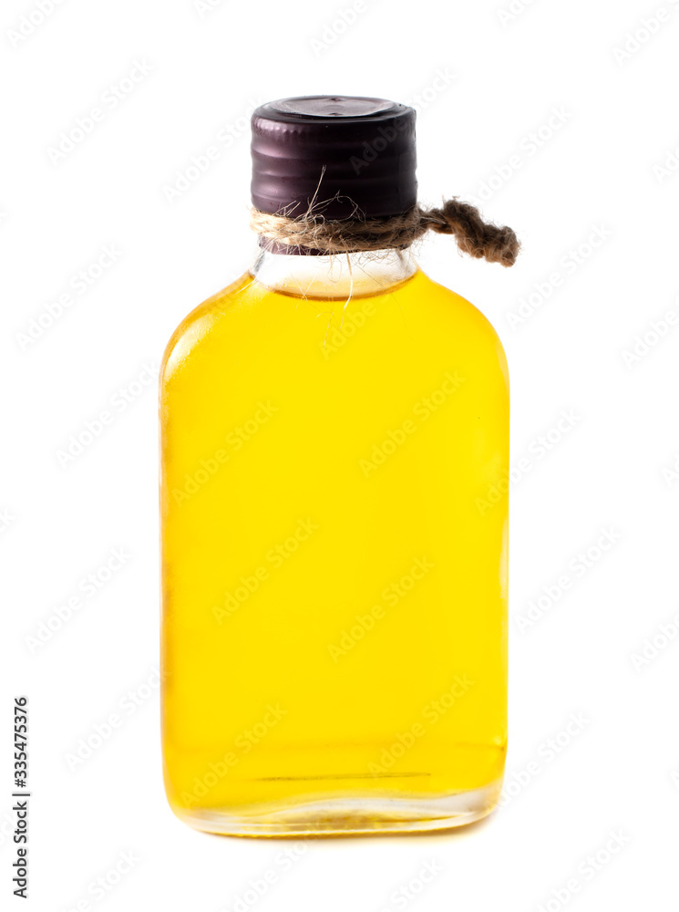 Yellow oil in a glass bottle isolated on a white Yellow oil in a glass bottle isolated on a white