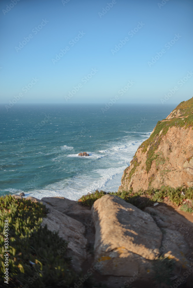 Portugal atlantic coast, waves crashing on the rocks warm sunny day horizon Portugal atlantic coast, waves crashing on the rocks warm sunny day horizon