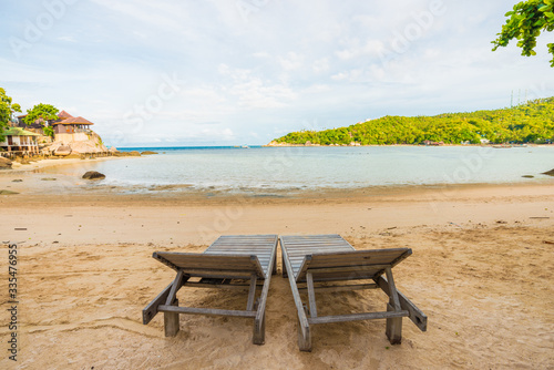 Empty beach chair white sand with coconut palm tree paradise sea