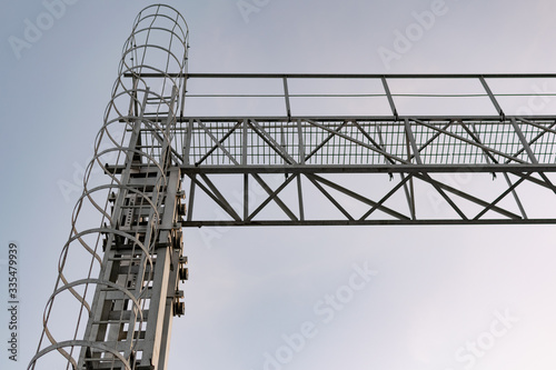 A metal structure made of thin but strong rings , chained together in a high tower stand for elevation to the top, covered with gray paint