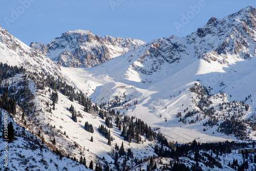 Shymbulak gorge and mountains with ski slopes. Winter mountains landscape. Nature, travel, adventure, hiking. © Adil