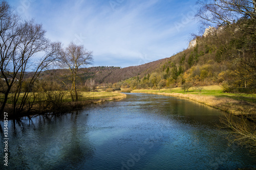 Germany, Clear water of river blau flowing alongside green nature landscape of swabian jura in blaubeuren