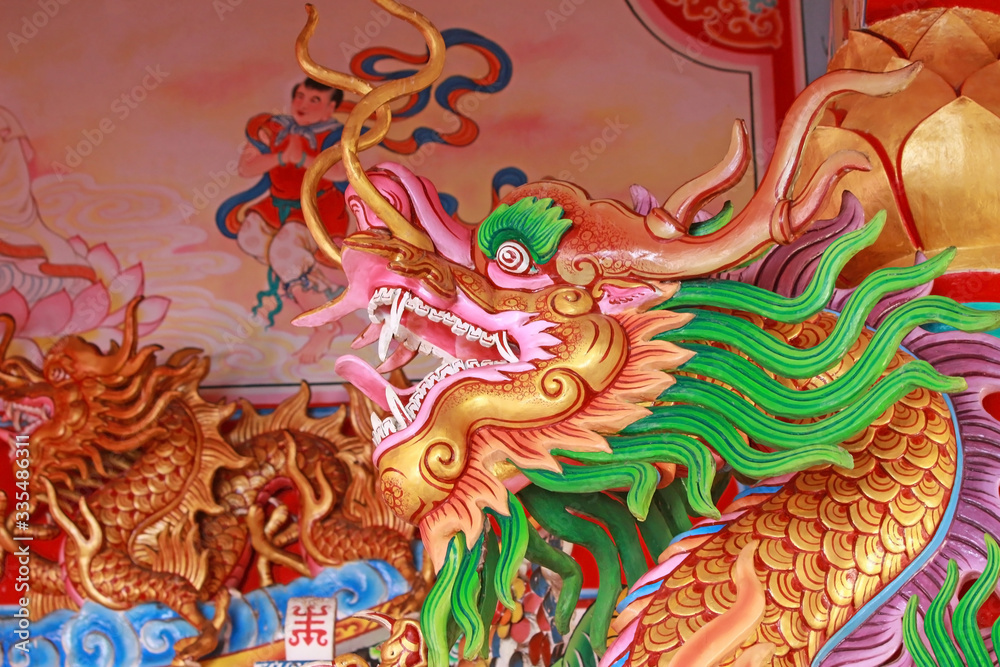 Head of a gold and green dragon statue at an old Chinese Buddhist temple in southeast Asia Head of a gold and green dragon statue at an old Chinese Buddhist temple in southeast Asia