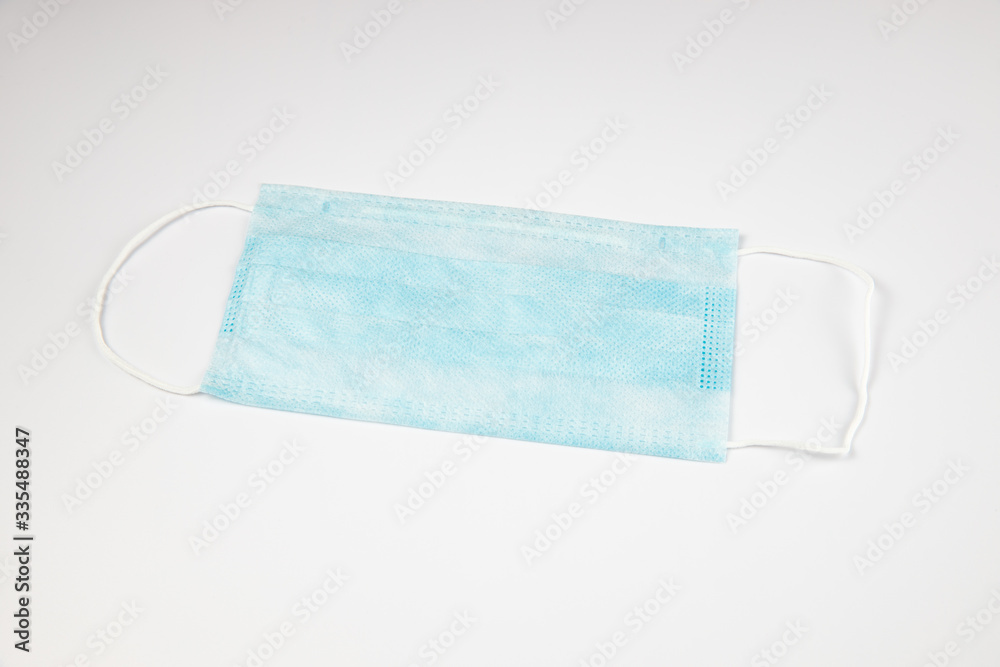 Fototapeta premium Antiviral medical mask for protection against coronavirus COVID-19. Medical protective mask on white background. Disposable surgical face mask cover the mouth and nose. Healthcare and medical concept.
