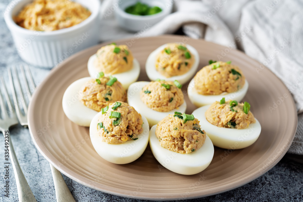 Canned Tuna deviled eggs with scallion on a light background Canned Tuna deviled eggs with scallion on a light background