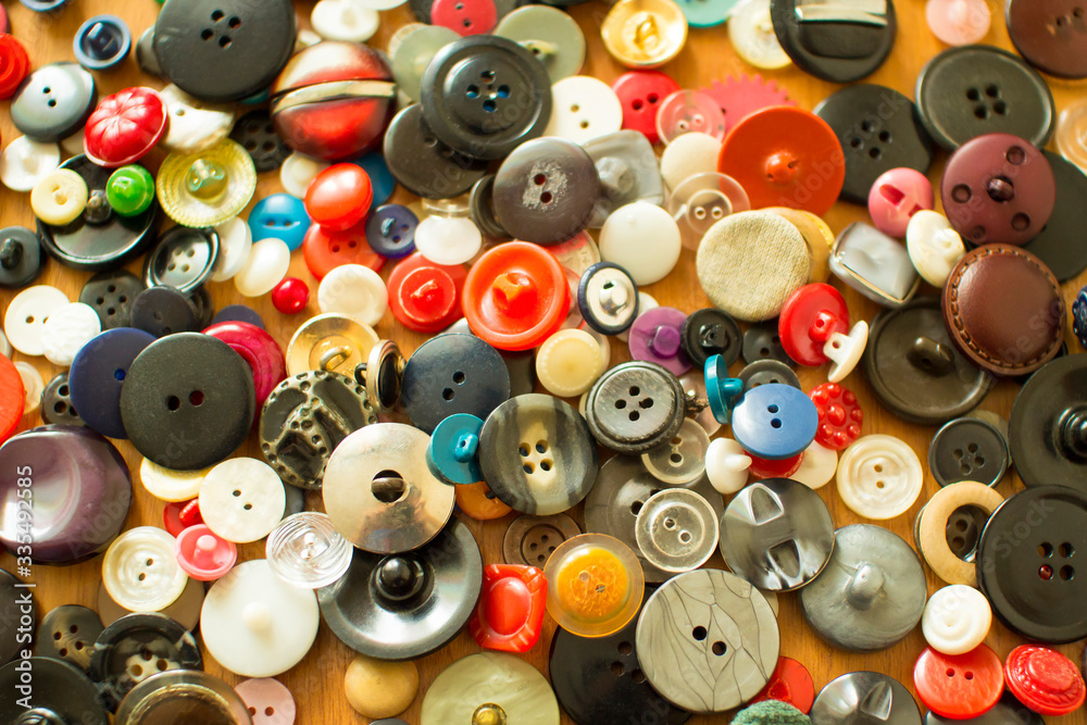 Old colored buttons on the table. background. top view. Needlework. Sewing.
