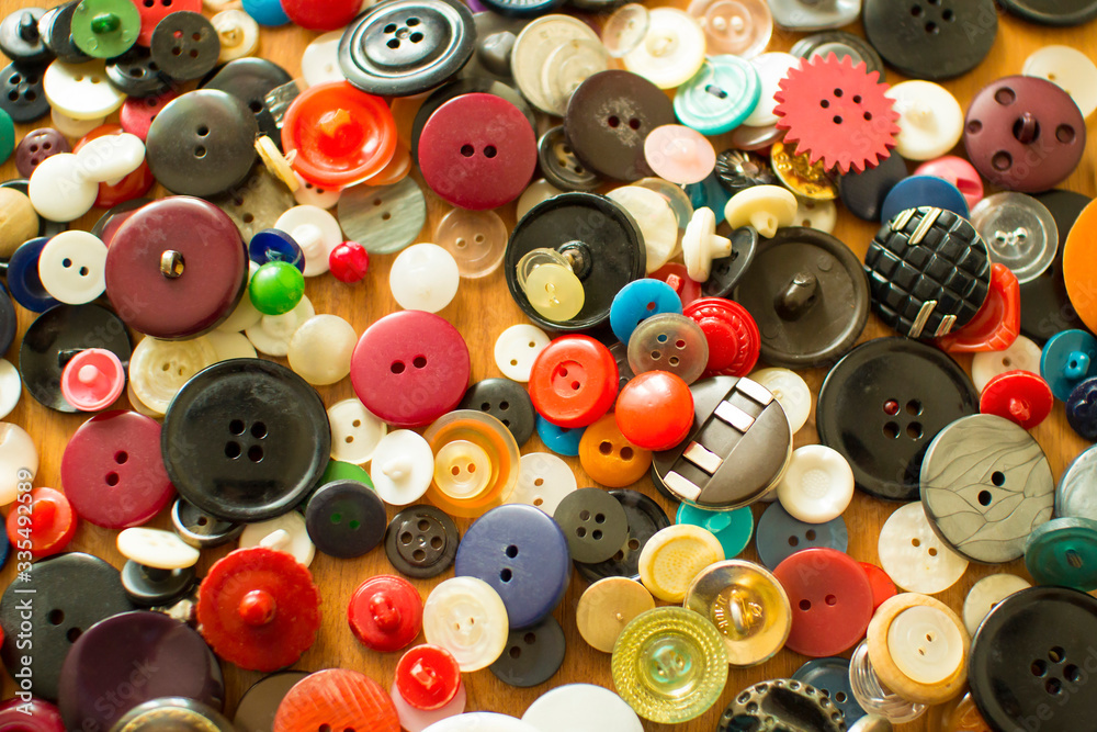 Old colored buttons on the table. background. top view. Needlework. Sewing.