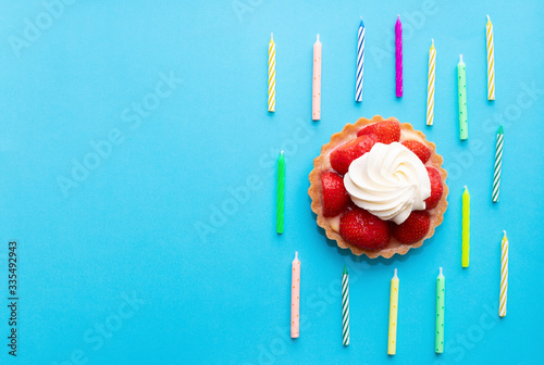 Birthday cake with strawberries and whipped cream.