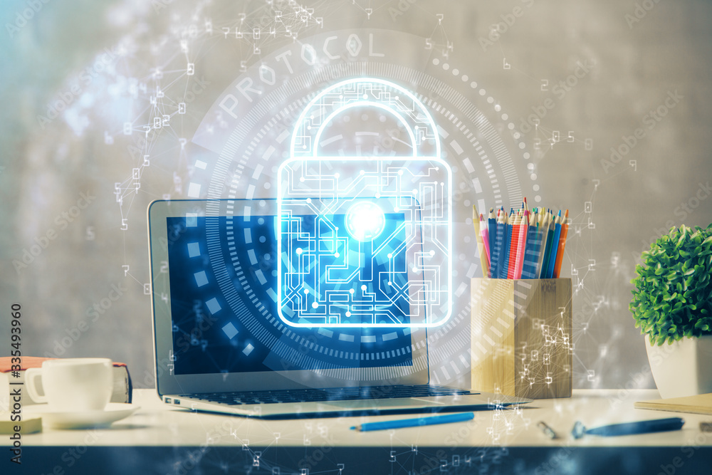 Double exposure of desktop with computer and lock icon hologram. Concept of data safety. Double exposure of desktop with computer and lock icon hologram. Concept of data safety.