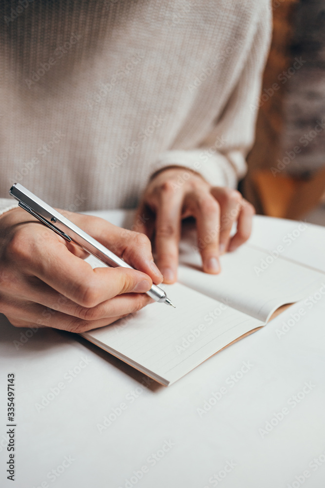 man writing a notes in notebook man writing a notes in notebook