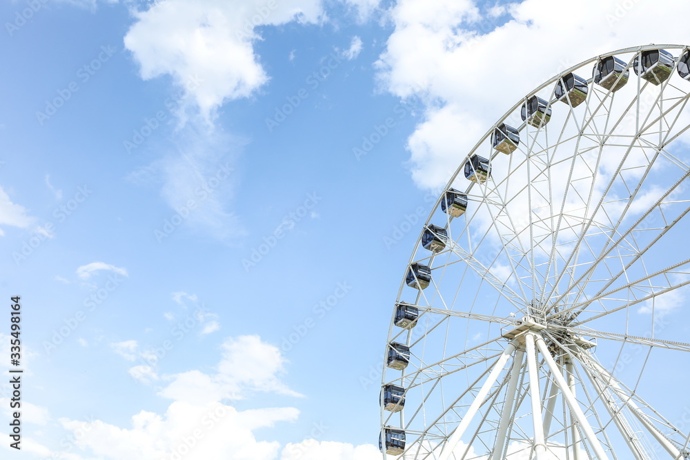ferris wheel against the background of the sunny sky