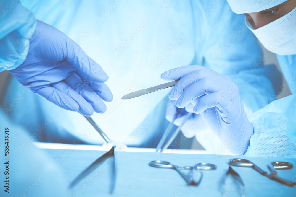 Close-up of medical team performing operation. Group of surgeons at work are busy of patient. Medicine, veterinary or healthcare and emergency in hospital Close-up of medical team performing operation. Group of surgeons at work are busy of patient. Medicine, veterinary or healthcare and emergency in hospital