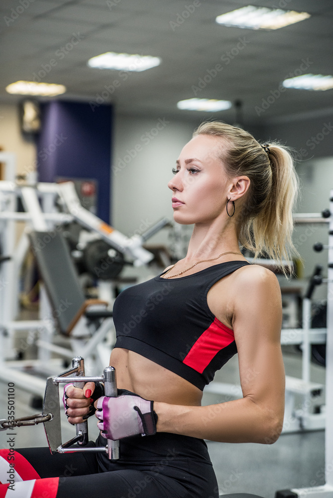Nice young girl does exercising in the gym Nice young girl does exercising in the gym