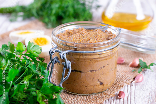 Fresh homemade chicken liver pate in a glass jar with