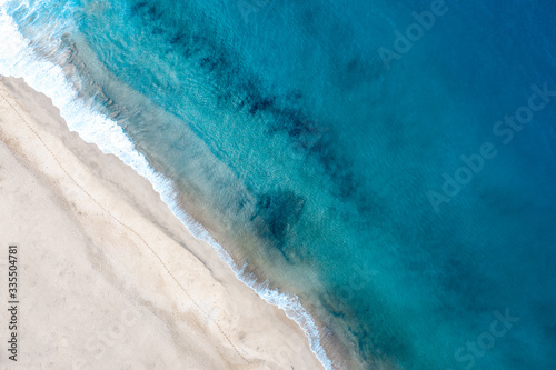 Top view of beautiful white sand beach with turquoise ocean water, aerial drone shot © Nikita