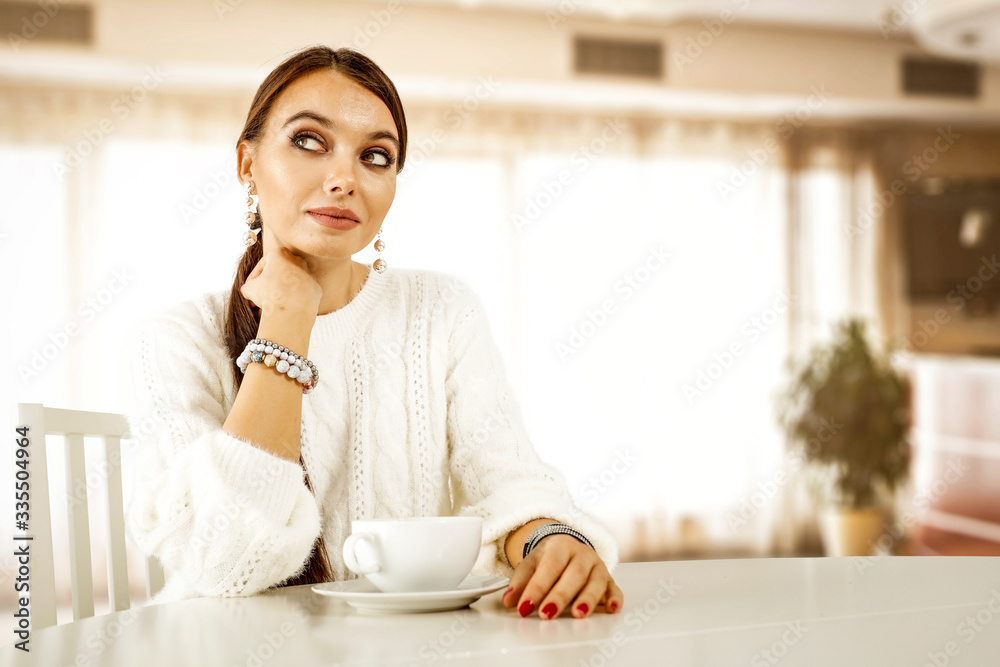 White table background of free space and home interior with white window.Slim young woman White table background of free space and home interior with white window.Slim young woman