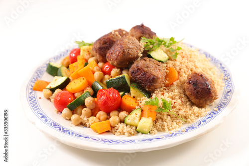 couscous with vegetable, semolina and meatball on white background