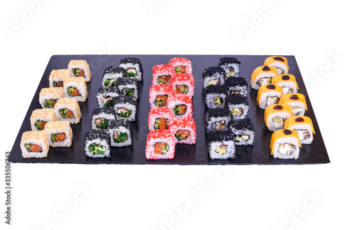 sushi set California rolls with fresh fish and cheese inside . Rolls on black stone isolated on white background. Sushi menu. Japanese food.