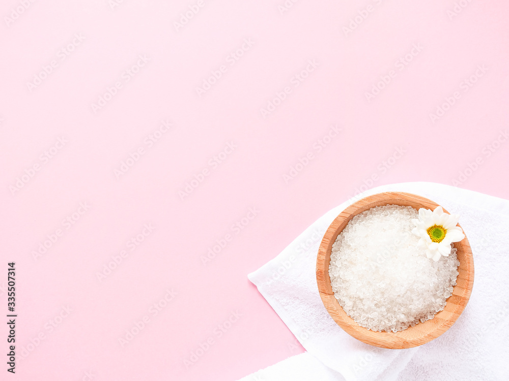 Spa flatlay composition. Sea salt, bath towel, flower on pink background. Copyspace, top view. Home care concept Spa flatlay composition. Sea salt, bath towel, flower on pink background. Copyspace, top view. Home care concept