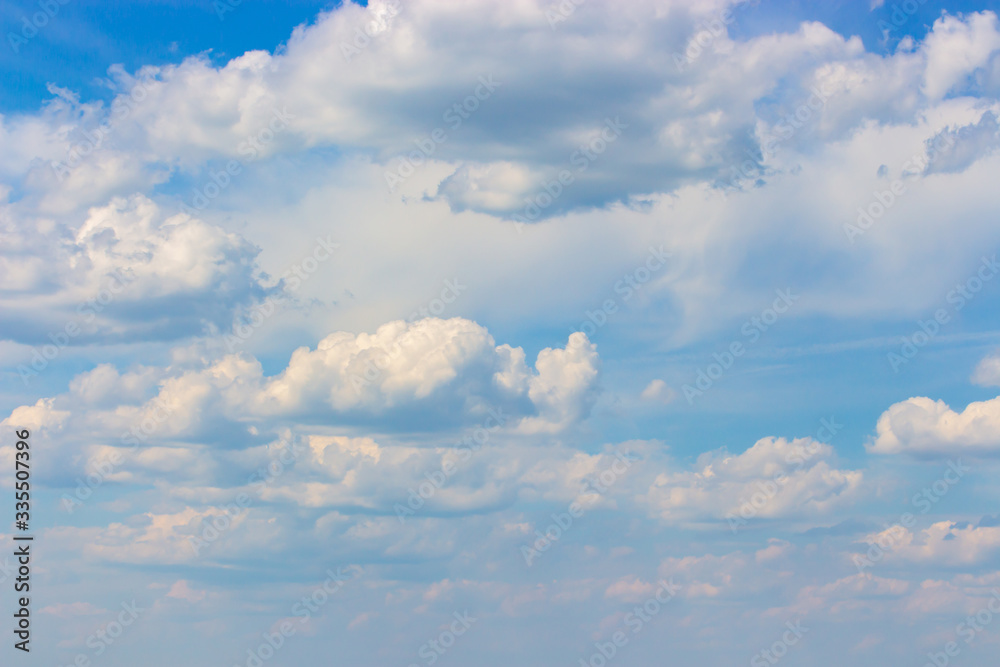 Obraz premium Cloudy weather, summer blue sky with lush cumulus clouds, cloudscape background wallpaper backdrop. Natural sky for design