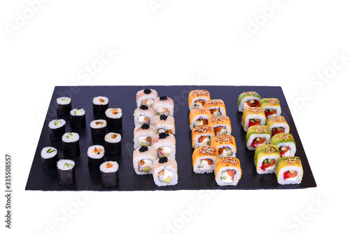 sushi set Omori rolls with fresh ingredients on black stone isolated on white background. Sushi menu. Japanese food.