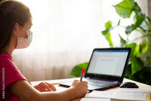Distance learning online education during the epidemic of Covid-19. Young schoolgirl studying online while coronavirus quarantine