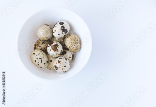 quail eggs in a basket, shot on a white background