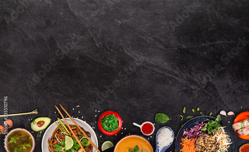 Asian food background with various ingredients on rustic stone background , top view. Vietnam or Thai cuisine.