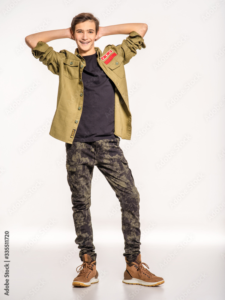Smiling young man in camouflage clothing. Happy Conscript in camouflage. Cheerful rookie in army clothes. Teenager in khaki military clothing. Smiling young man in camouflage clothing. Happy Conscript in camouflage. Cheerful rookie in army clothes. Teenager in khaki military clothing.
