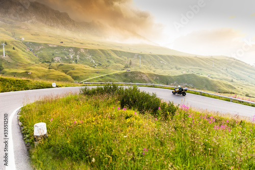 Motorcycle driver riding in Dolomite pass, Italy, south Europe. photo