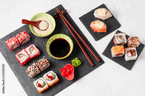 Obraz na płótnie Japanese cuisine. Assorted sushi maki gunkan roll on white table w salonie